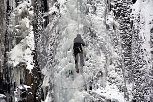 Ice climber on the frozen Boyana Waterfall in Vitosha Mountain near Sofia City, Bulgaria