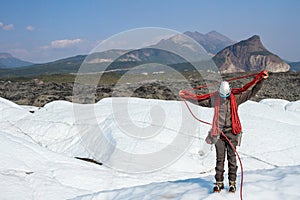 Ice climbing guide coiling a climbing rope over his neck on the Matanuska Glacier in Alaska