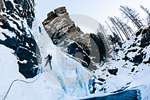 Ice climbing: male climber on a icefall in italian Alps. photo