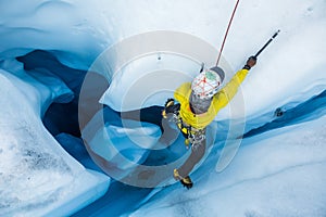 Ice climbing out of a large moulin cut into the ice of the Matanuska Glacier