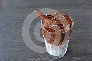 Ice cocoa drink with cinnamon on wood table