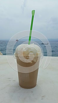 Ice coffee against the Mediterranean sea