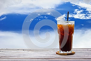 Ice coffee,americano,lemon tea,cola on wood table with blue sky and clouds nature background. Copy space