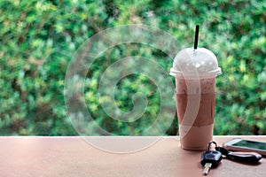 Ice coffee , Key and smartphone in cafe