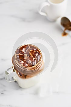 Ice coffee with milk in mason jar