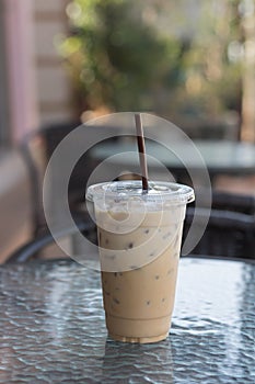 Ice Coffee in plastic take away cup.Outdoor cafe.summer drinking