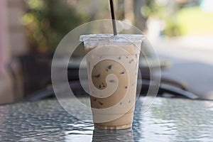 Ice Coffee in plastic take away cup.Outdoor cafe.summer drinking