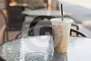 Ice Coffee in plastic take away cup.Outdoor cafe.summer drinking