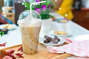 Ice coffee on a wood table with dessert refreshing look of the drink