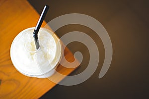 Ice coffee on a wooden table in coffee shop