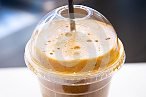 Ice cold coffee froth in a plastic cup