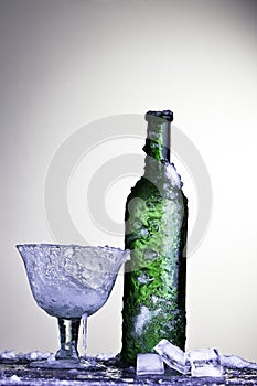 Ice cold drink frozen wine glass and bottle