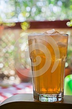 Ice cold drink on a hot summer day, sunny balcony in the background