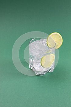 Ice cold drink with lime slices attached. Detox soda with lime flavor