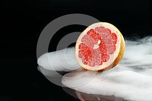 Ice cold grapefruit in fragrant smoke