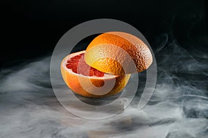 Ice cold grapefruit in fragrant smoke