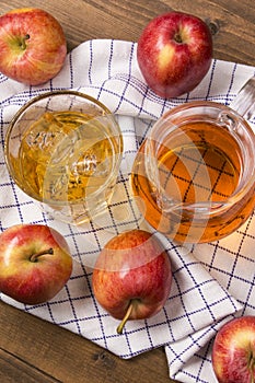 Ice cold homemade apple juice in a glass with ice cube