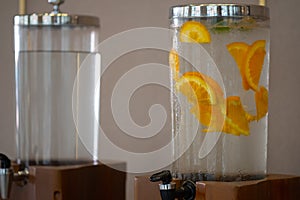 Ice cold water freshened put with slices of orange fruit