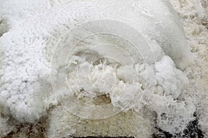 Ice cold water splashes from flowing river