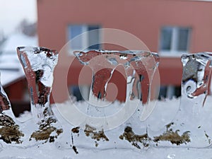 Ice columns with house in the background