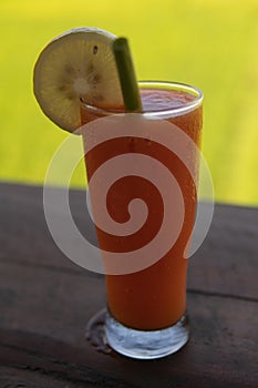 Ice cool refreshing juice drink with a lush green background