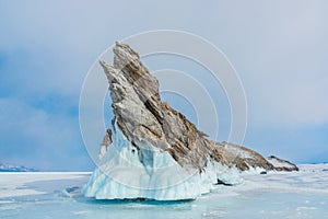 Ice-covered Ogoy Island in the Maloye More Bay of Baikal in winter. Winter landscape. Siberia, Russia