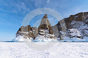 Ice-covered Ogoy Island in the Maloye More Bay of Lake Baikal in winter. Siberia, Russia