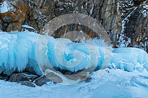 Ice-covered Ogoy Island in the Maloye More Strait of Baikal in winter. Siberia, Russia