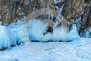 Ice-covered Ogoy Island in the Maloye More Strait of Baikal in winter. Siberia, Russia