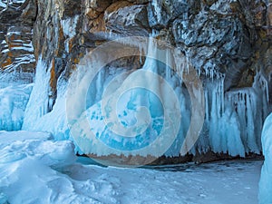 Ice-covered Ogoy Island in the Maloye More Strait of Baikal in winter. Siberia, Russia