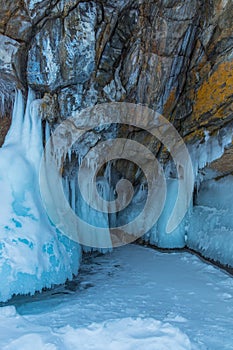 Ice-covered Ogoy Island in the Maloye More Strait of Baikal in winter. Siberia, Russia