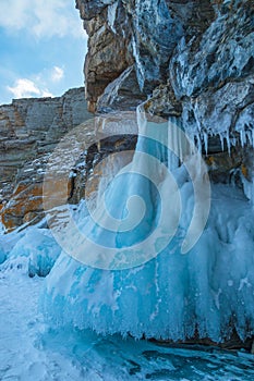 Ice-covered Ogoy Island in the Maloye More Strait of Baikal in winter. Siberia, Russia