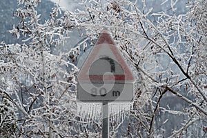 Ice-covered road sign in the Italian Alps in winter