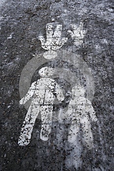 Ice covered sidewalk with a pedestrian path sign