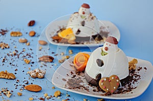 Ice cream background in the shape of two edible snowmen on white plates close up. Top view. Creative idea for Christmas.