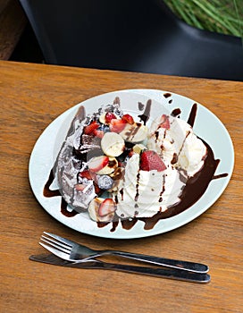 Ice cream, banana, strawberry, chocolate waffles with chocolate