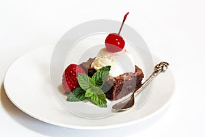 Ice cream and browny with cherry and mint