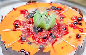 Ice cream cake covered with jam and fruits