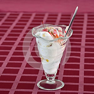 Ice cream with cherries and fillings on the table