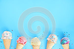 Ice cream cone bottom border over a blue background photo