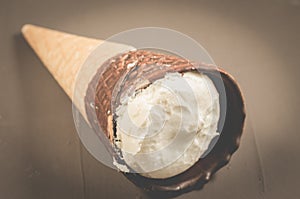 Ice cream with cone in chocolate on a dark background/ice cream with cone in chocolate on a dark background, close up