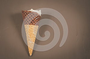 ice cream with cone in chocolate on a dark background/ice cream with cone in chocolate on a dark background, top view and