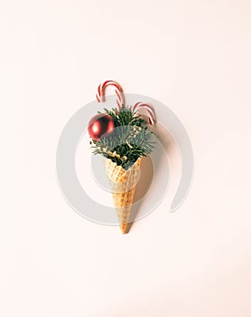 Ice Cream Cone with Christmas Decorations. Minimal christmas concept. Top view. Copy space. Flat lay. Toning