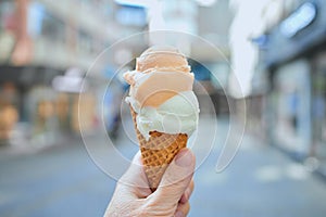 Ice cream in a cone in a hand