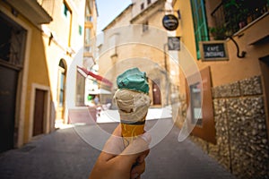 Ice Cream cone in a hand in the street of Palma de Mallorca