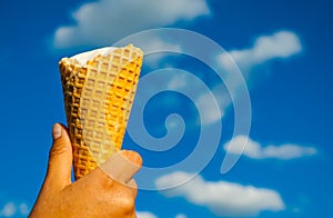 Ice cream cone by Soft cream milk in hot summer day on blue sky background