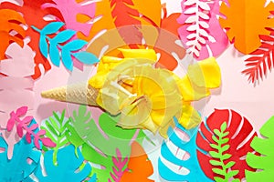 ice cream cone with yellow petals, on a jungle colorful background, creative summer design melting ice cream