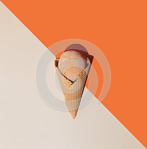 Ice cream cones with frozen summer fruit on orange and beige background. Minimal summer food concept. Flat lay