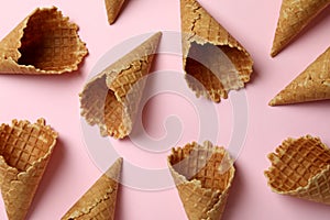 Ice cream cones on pink background, top view