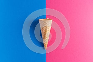 Ice cream cornet over blue and pink background